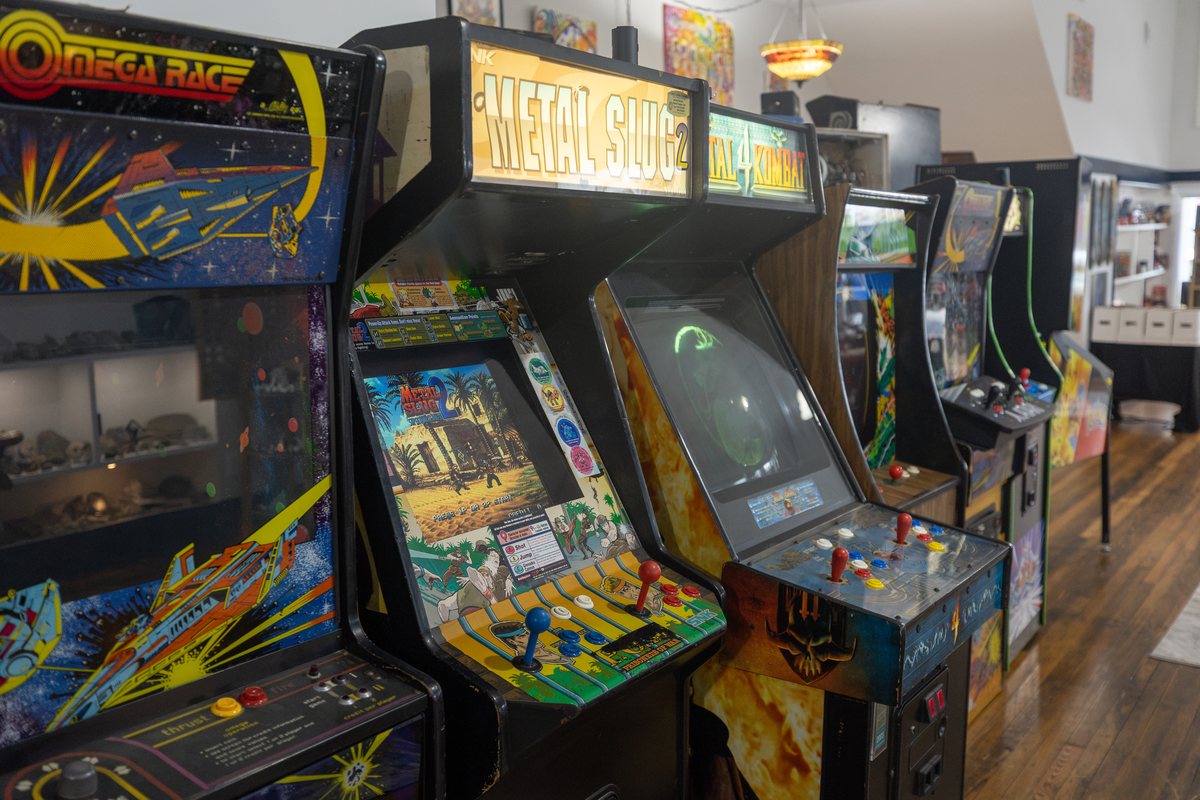 The arcade cabinet row at The Art-Cade: Omega Race and Metal Slug